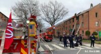 Fire apparatus and firefighters at the scene of an apartment fire in Southwest D.C.