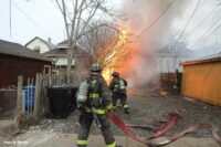 Chicago firefighters flake out a hoseline on the fireground