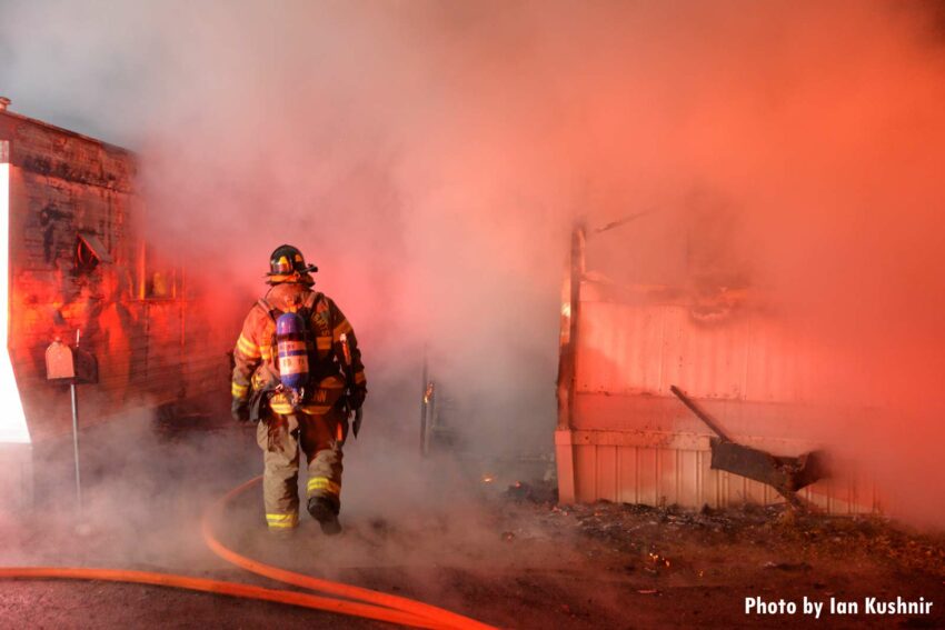 Firefighter amid smoke during a trailer fire