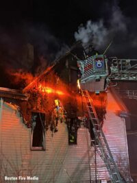 Tower Ladder bucket outside house fire