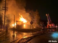 Indianapolis fire apparatus and firefighters battle a large fire