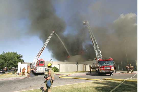 Big water delivery to fire; multiple aerial devices at work