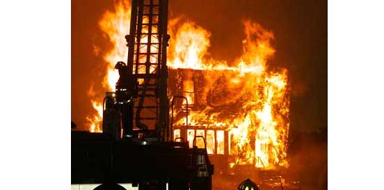 Flames tear through a structure