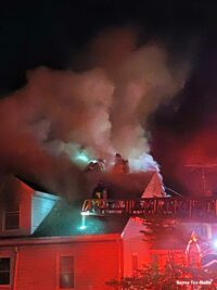 Aerial ladder and Boston firefighters on roof