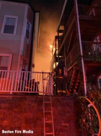 Firefighters working at a seven-alarm fire in South Boston