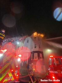 Flames peak from the top of a one home