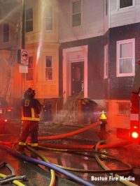 Firefighters and hoselines at the 7-alarm fire