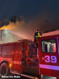 Boston fire apparatus with firefighter using master stream