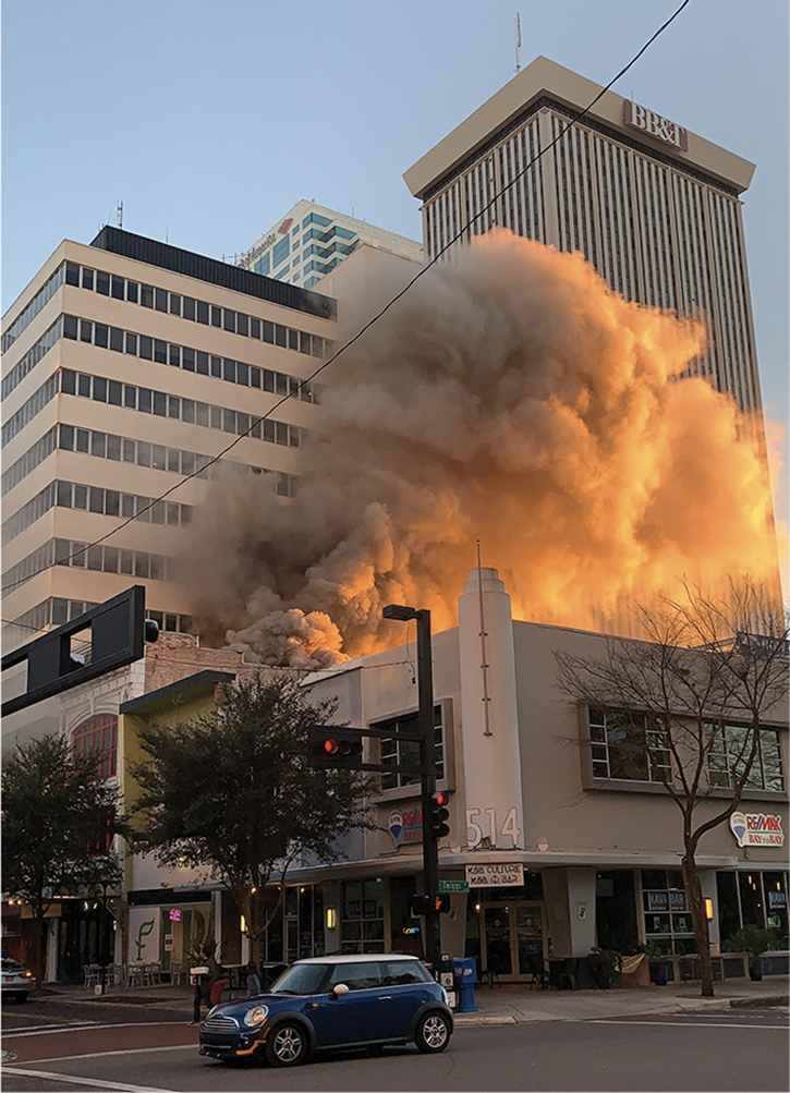 Prior to arrival, a large amount of smoke is seen from the roof of the involved structure. Conditions had changed greatly on arrival.