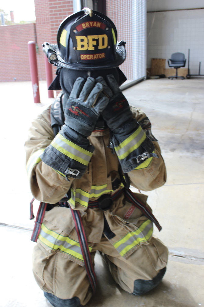 Pull the hood over your SCBA mask and use your hands to protect the mask from direct flames and heat.