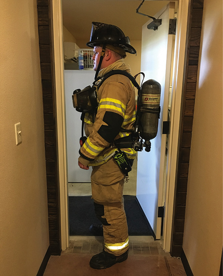 In the same doorway, the firefighter’s self-contained breathing apparatus (SCBA) is causing a choke point. 