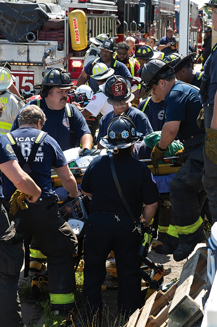 Crews remove the last trapped ironworker to the waiting University of Chicago Aeromedical Network Helicopter.