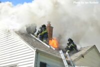 Flames shoot through the roof of the home