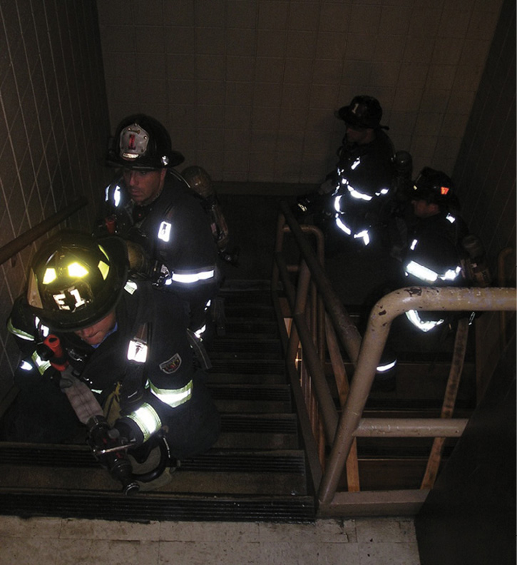 Firefighters advancing up a stairwell