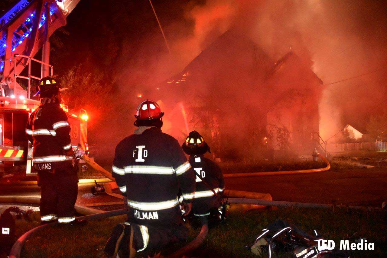 Indianapolis firefighters in front of a burning church building