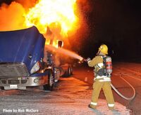 A City of Los Angeles firefighter puts water on a burning tractor trailer