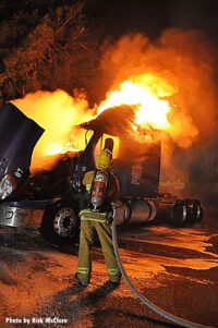 A firefighter works a tractor trailer fire in Los Angeles