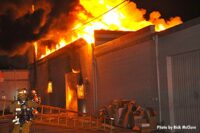 Shot of flames shooting through the roof of the building