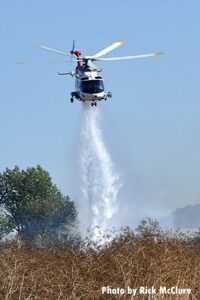 Helicopter making a drop on vegetation fire in Los Angeles