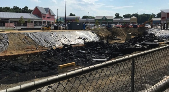 Postfire view of excavated drainage system area including the fire area in the foreground and subsequent equipment access.