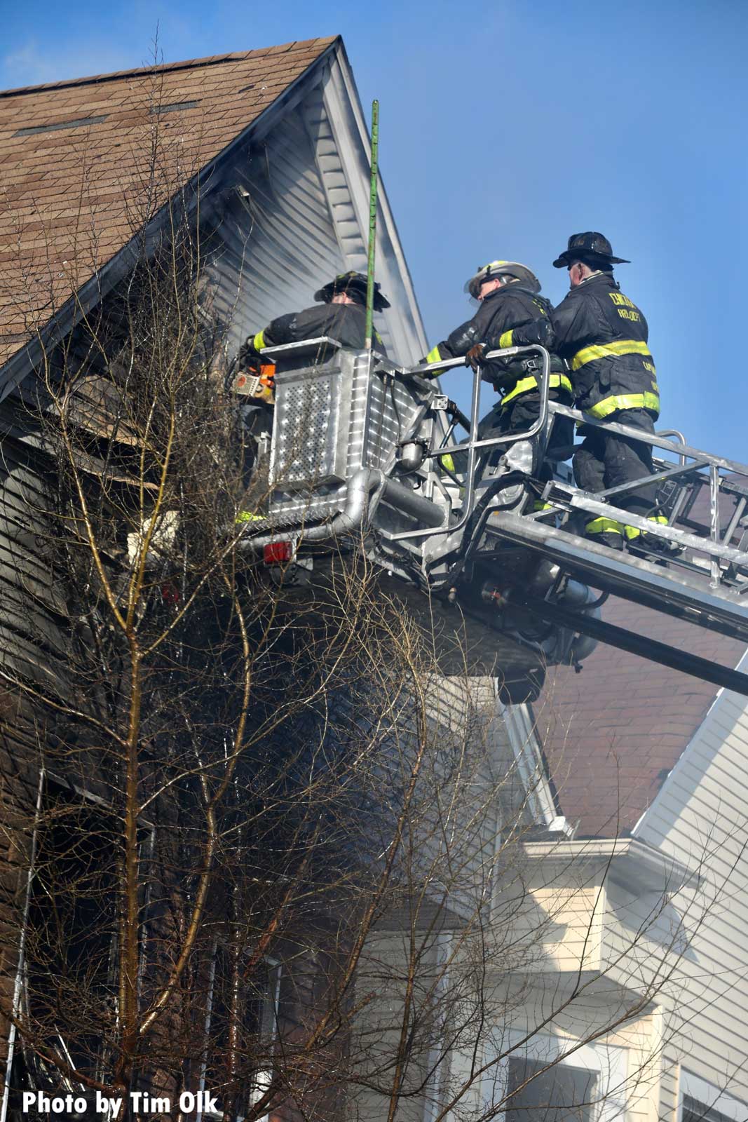 Firefighters working from a bucket at a fatal Chicago fire