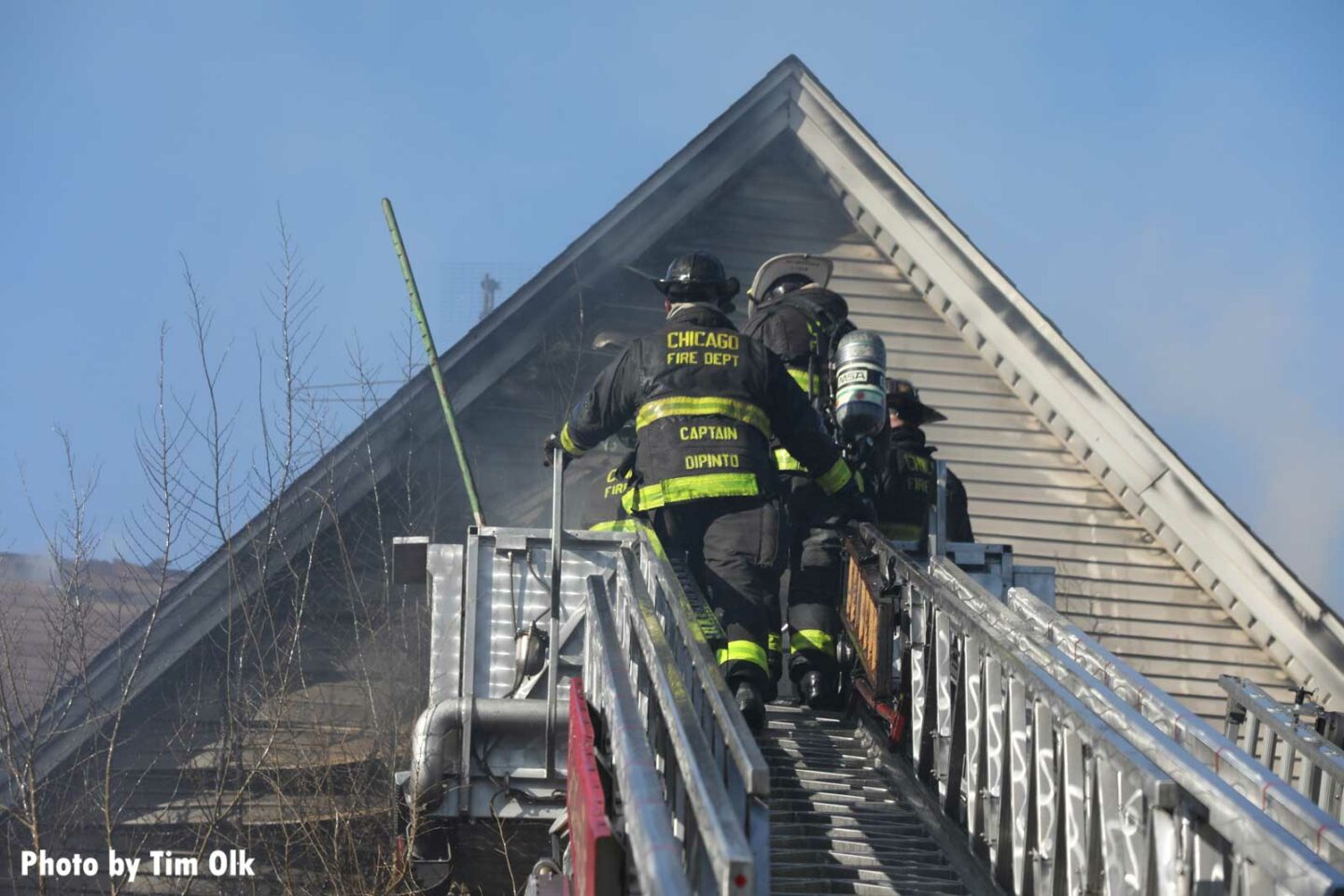 Chicago Fire Department members on a tower ladder at a double-fatal fire