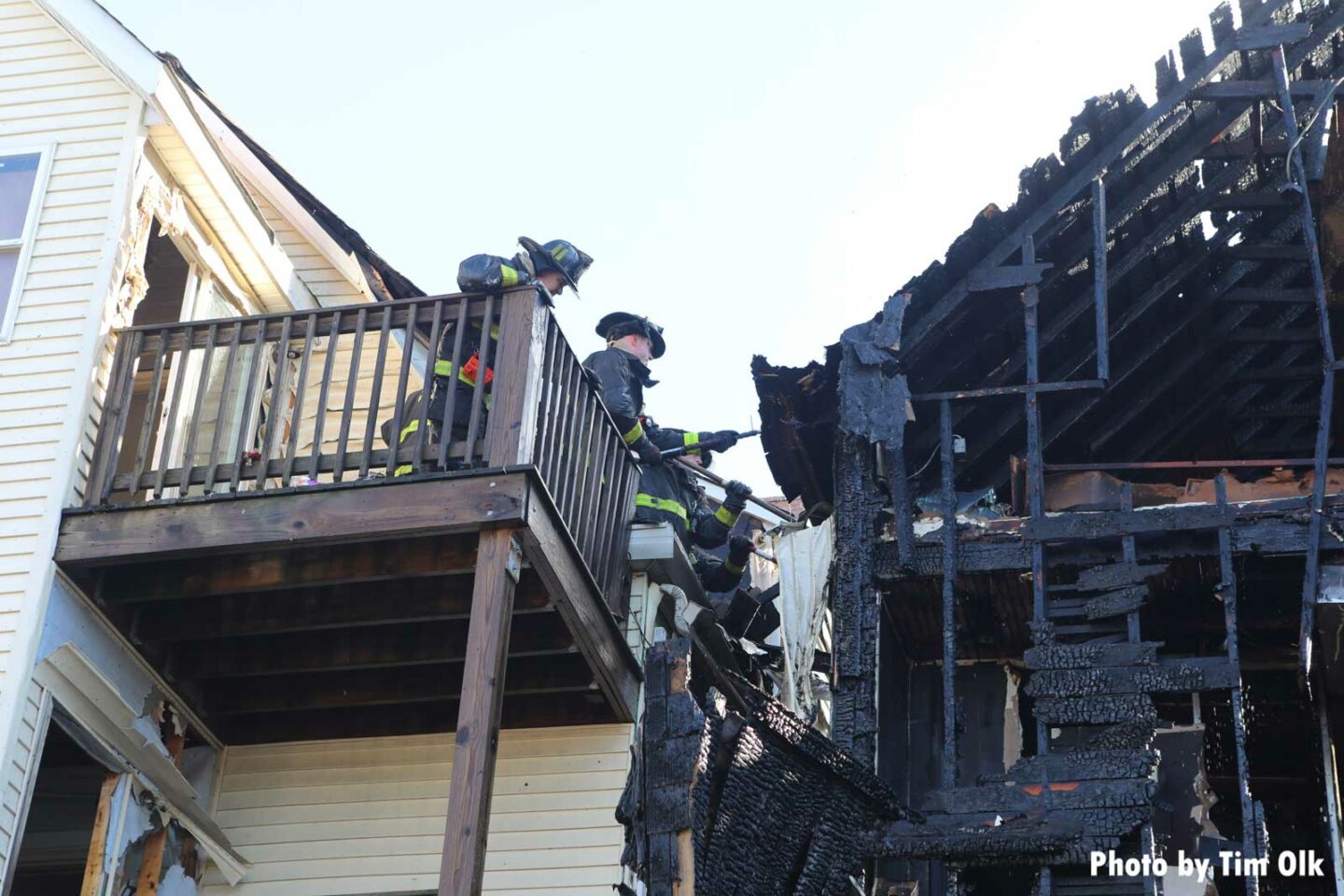 Chicago firefighters operate from an exposure dwelling to protect it from fire extension