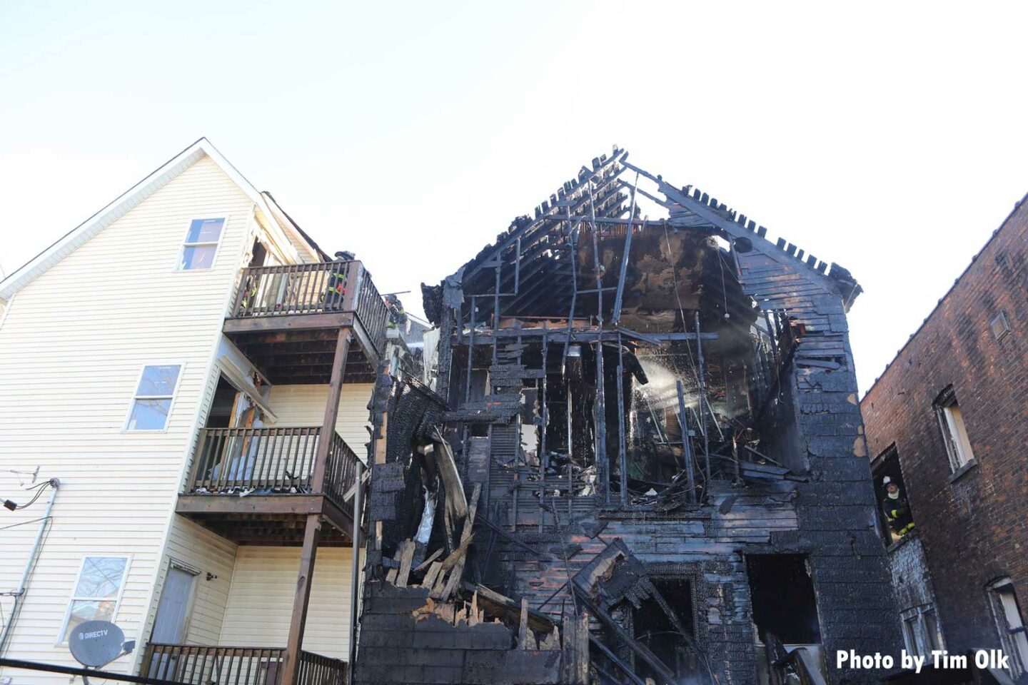 Charred residence next to exposure building