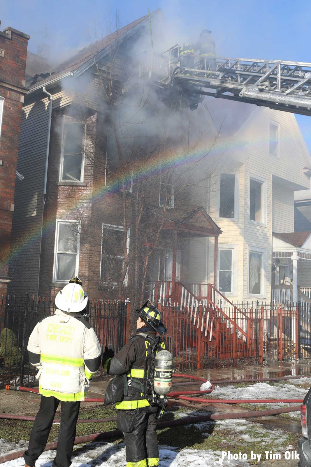 Rainbow over Chicago firefighters on the ground and on tower ladder