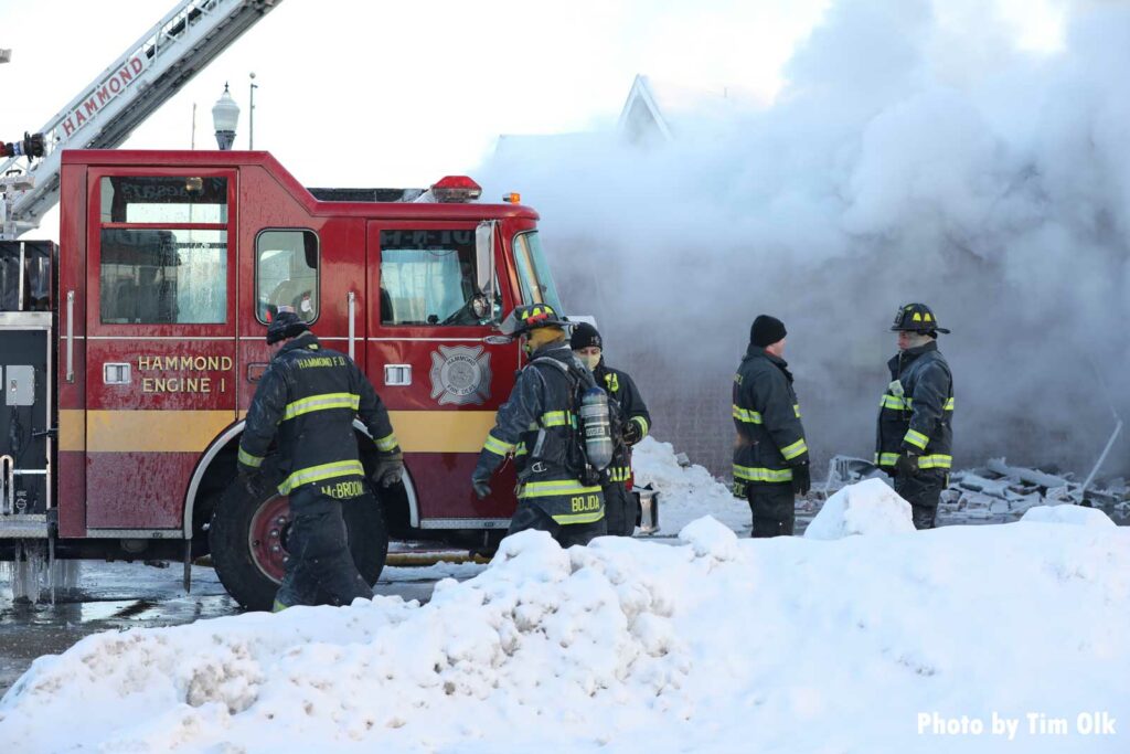 Firefighters gather at the scene of the fire