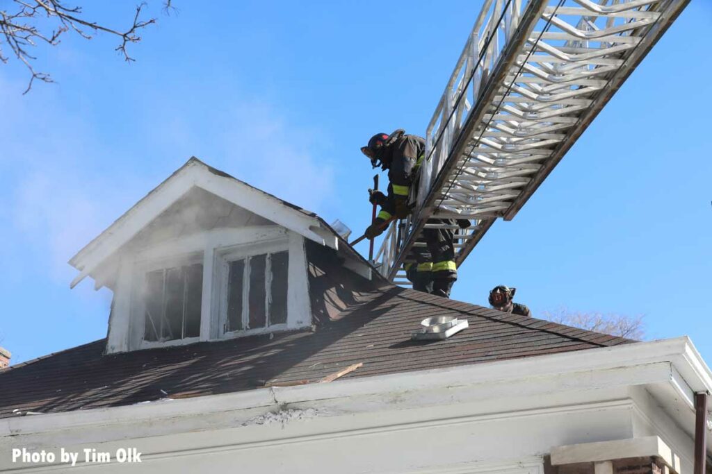 Chicago firefighters on an aerial performing roof ops