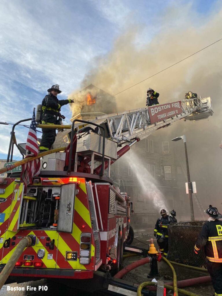 Boston firefighters on Tower Ladder at three-alarm fire