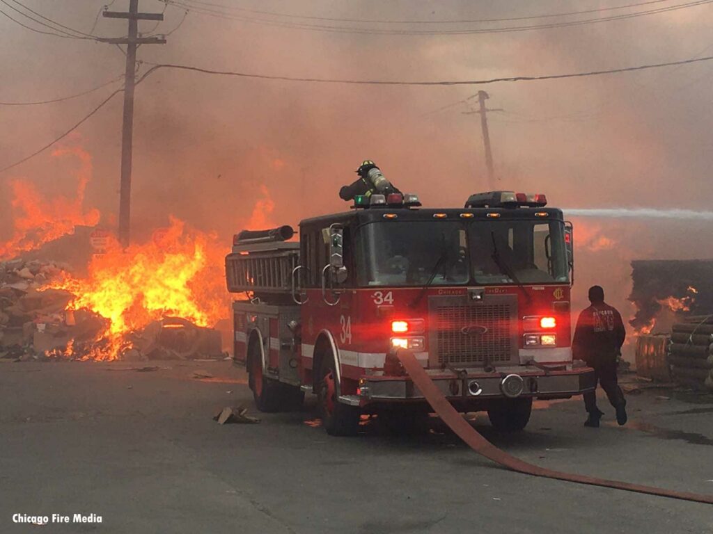 Chicago fire apparatus with flames in the backgroun