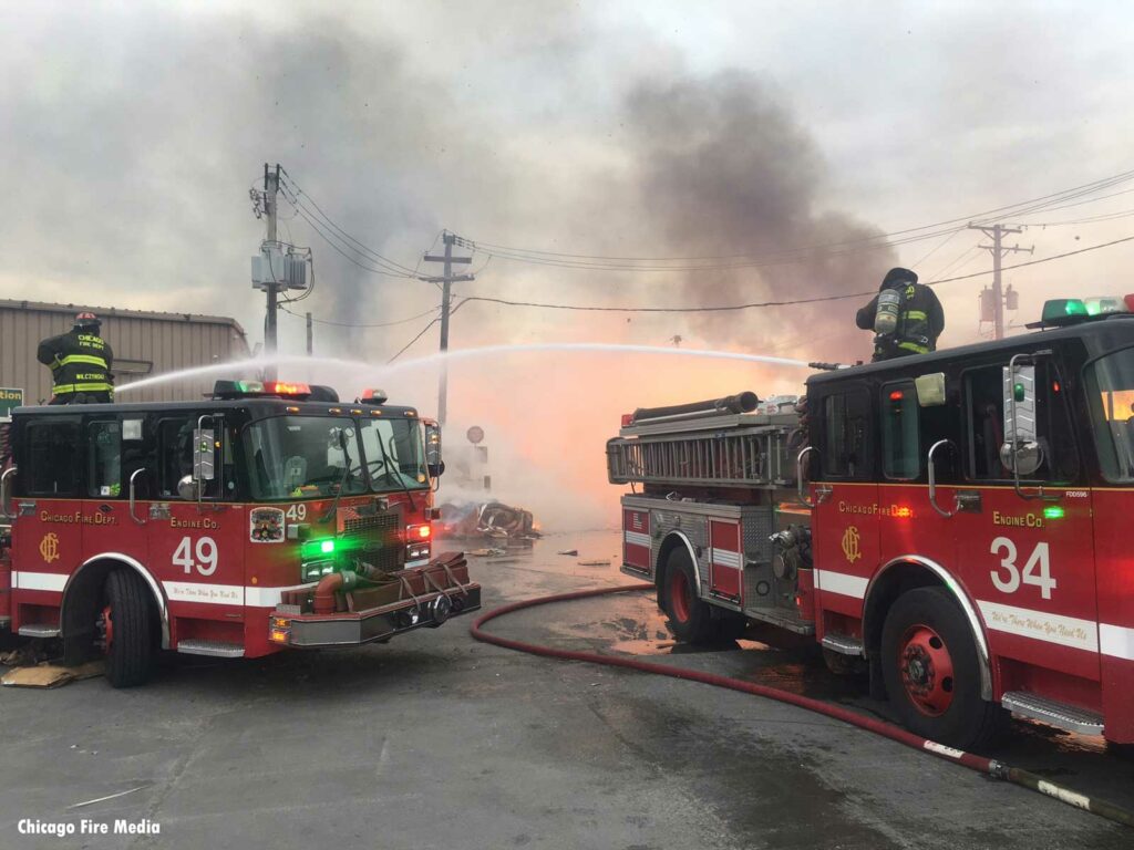 Chicago firefighters on two apparatus put hose streams on fire