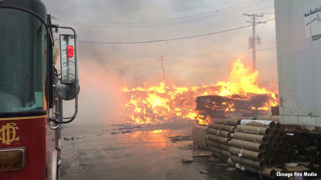 Chicago fire truck with flames burning through materials at scene