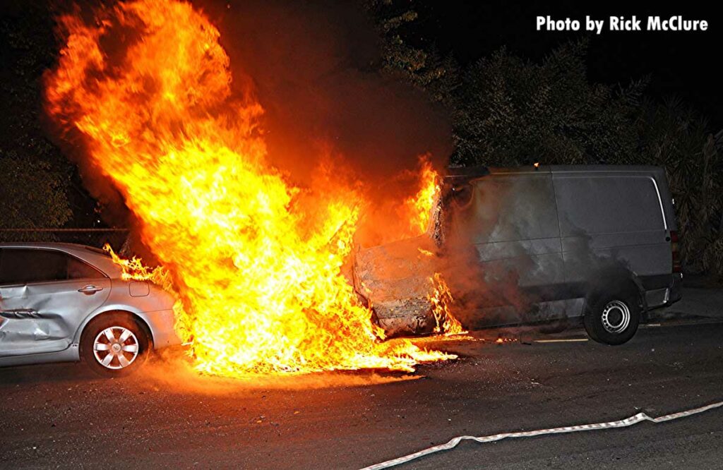 Flames from a burning van spread to a car