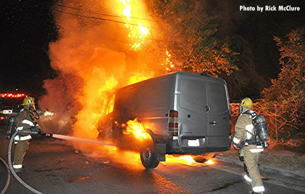 Two firefighters at a vehicle fire in Los Angeles