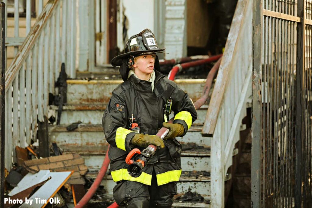 Chicago firefighter with hoseline in front of building