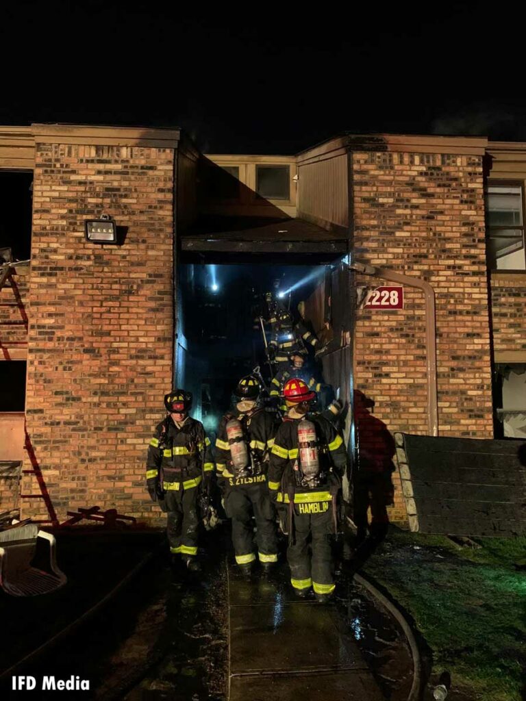 Damage to building as firefighters work at scene of fire in Indianapolis