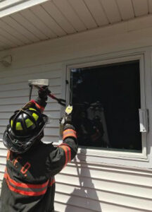 Firefighter with tool at window