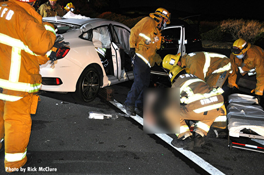 LAFD firefighters remove a victim from a crash scene