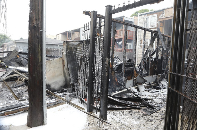 A company at a garage fire applies Class A foam for initial knockdown and overhaul.