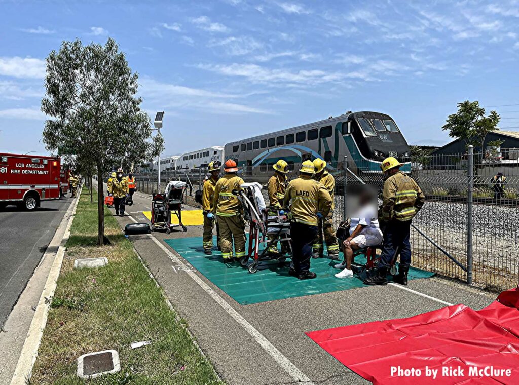 Firefighters assist a patient after Los Angeles train incident