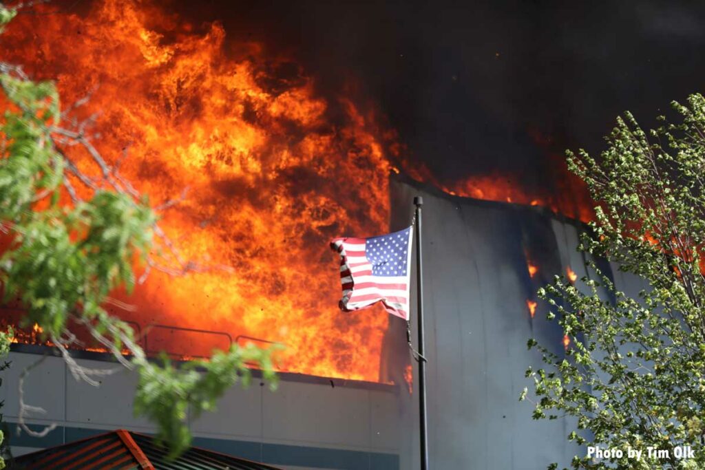 American flag in front of flames