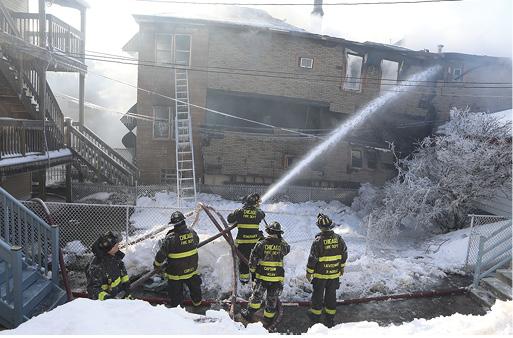 A ladder is still deployed on the B side of the structure while crews fight the fire from a defensive position. 