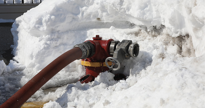 Snow accumulation around a fire hydrant. This is a glimpse of the conditions that crews had to overcome to bring this fire under control.