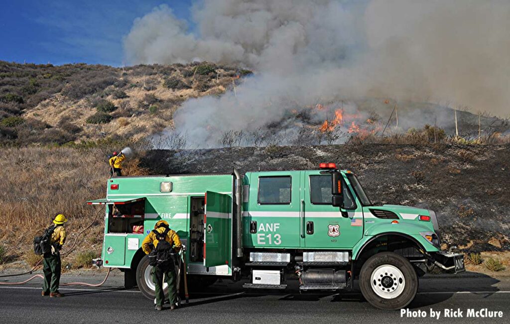 U.S. Forest Service firefighters with wildland vehicle at Route Fire