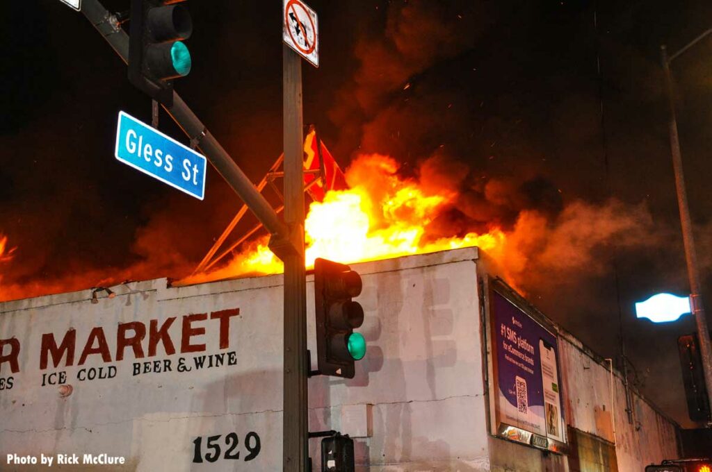 Flames emerge from commercial building's roof