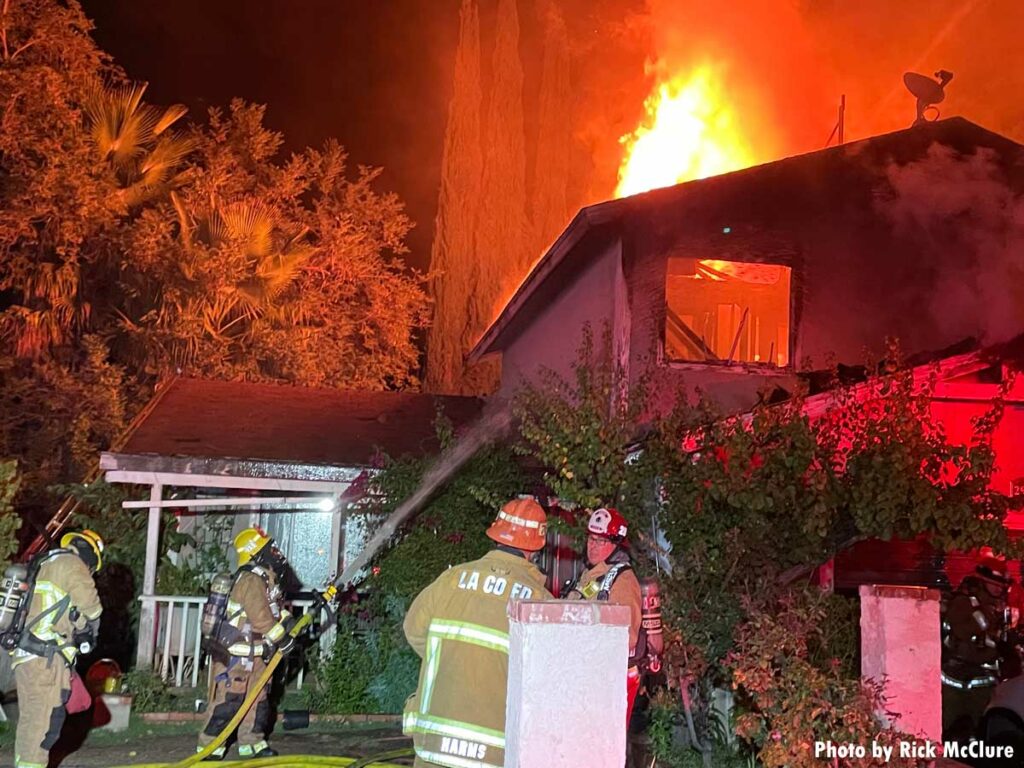 Los Angeles County firefighters with hose at fire