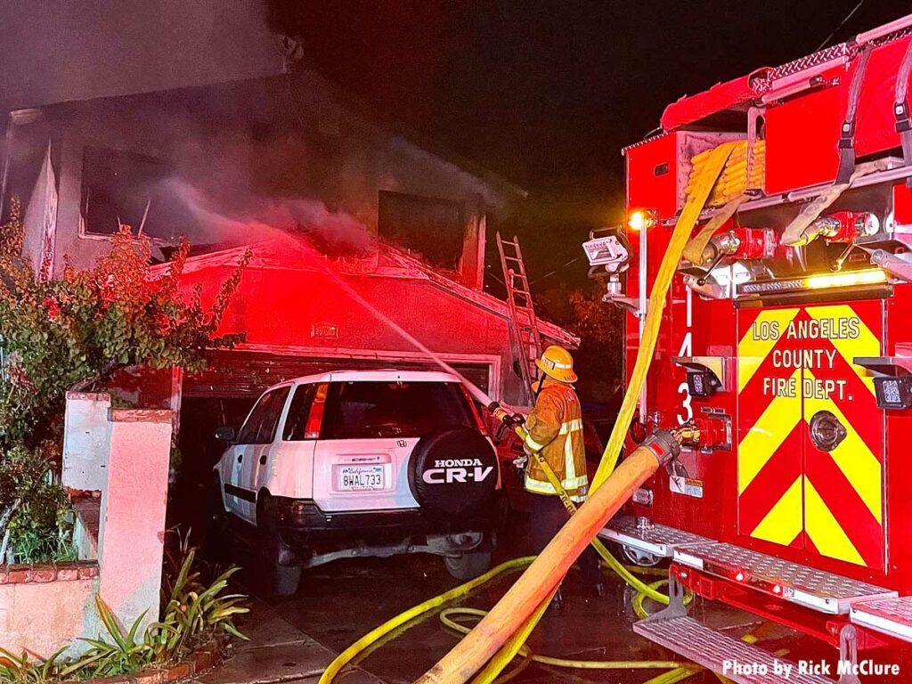 Los Angeles County fire truck and firefighter with a hoseline